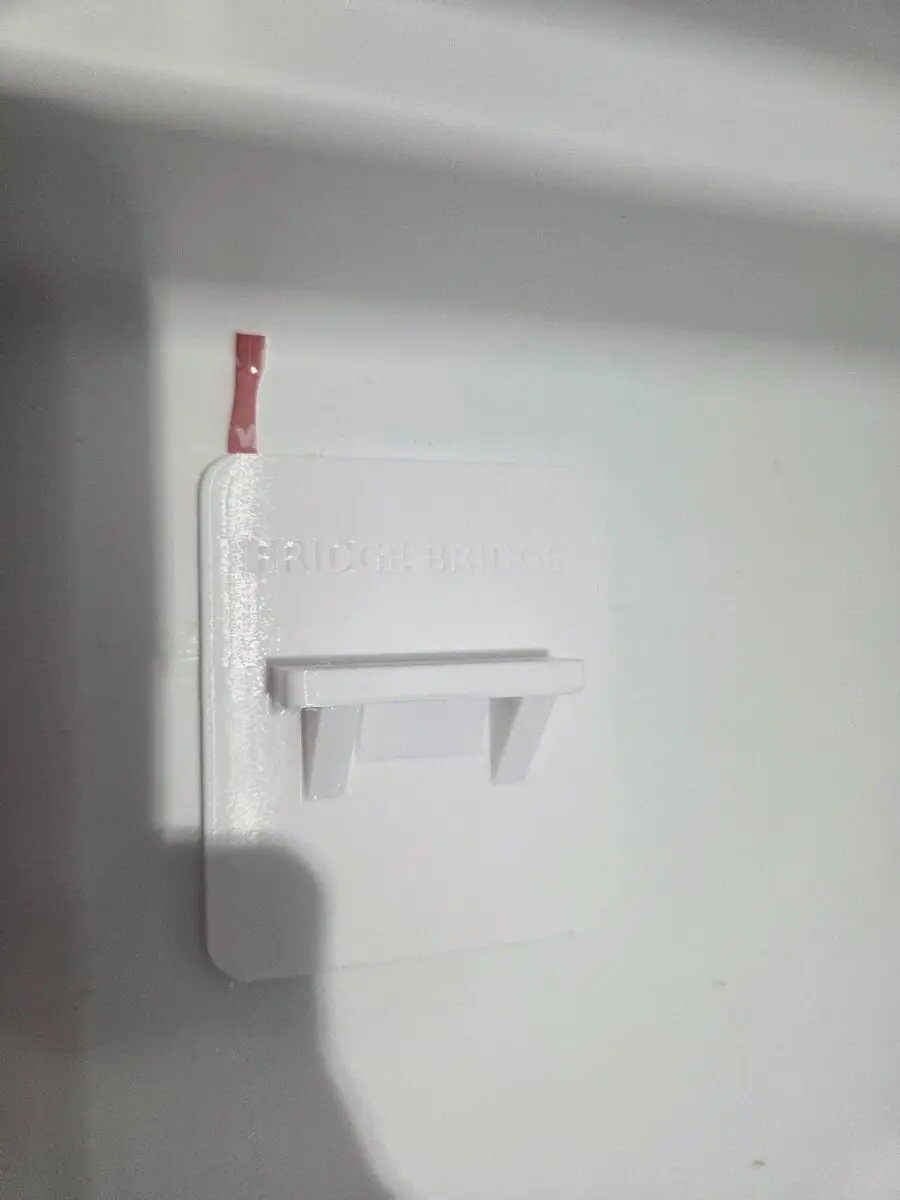 Fridge Bridge Support Bracket installed on a refrigerator liner with a red movement witness mark