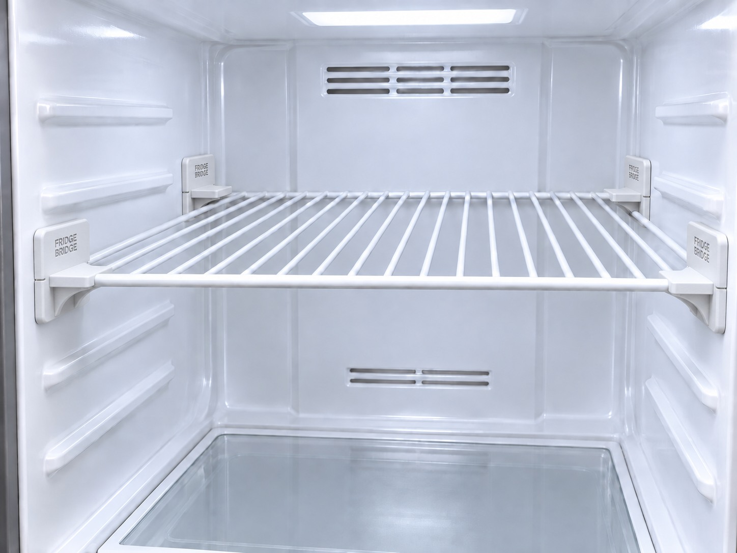 Adjustable fridge shelf supported by four Fridge Bridge Support Brackets inside a refrigerator